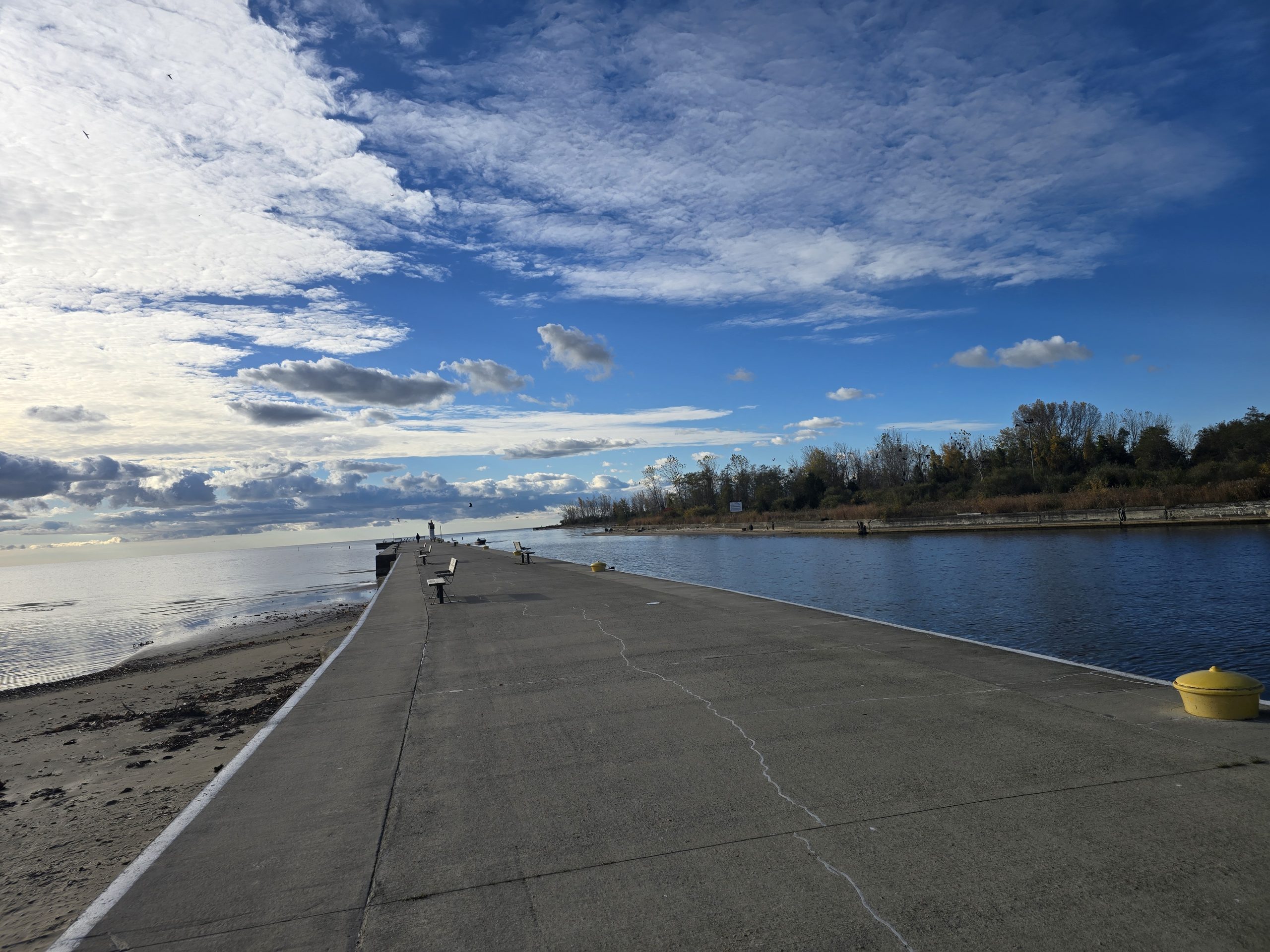 Port Burwell pier along the sandy beaches with blue cloudy skies.