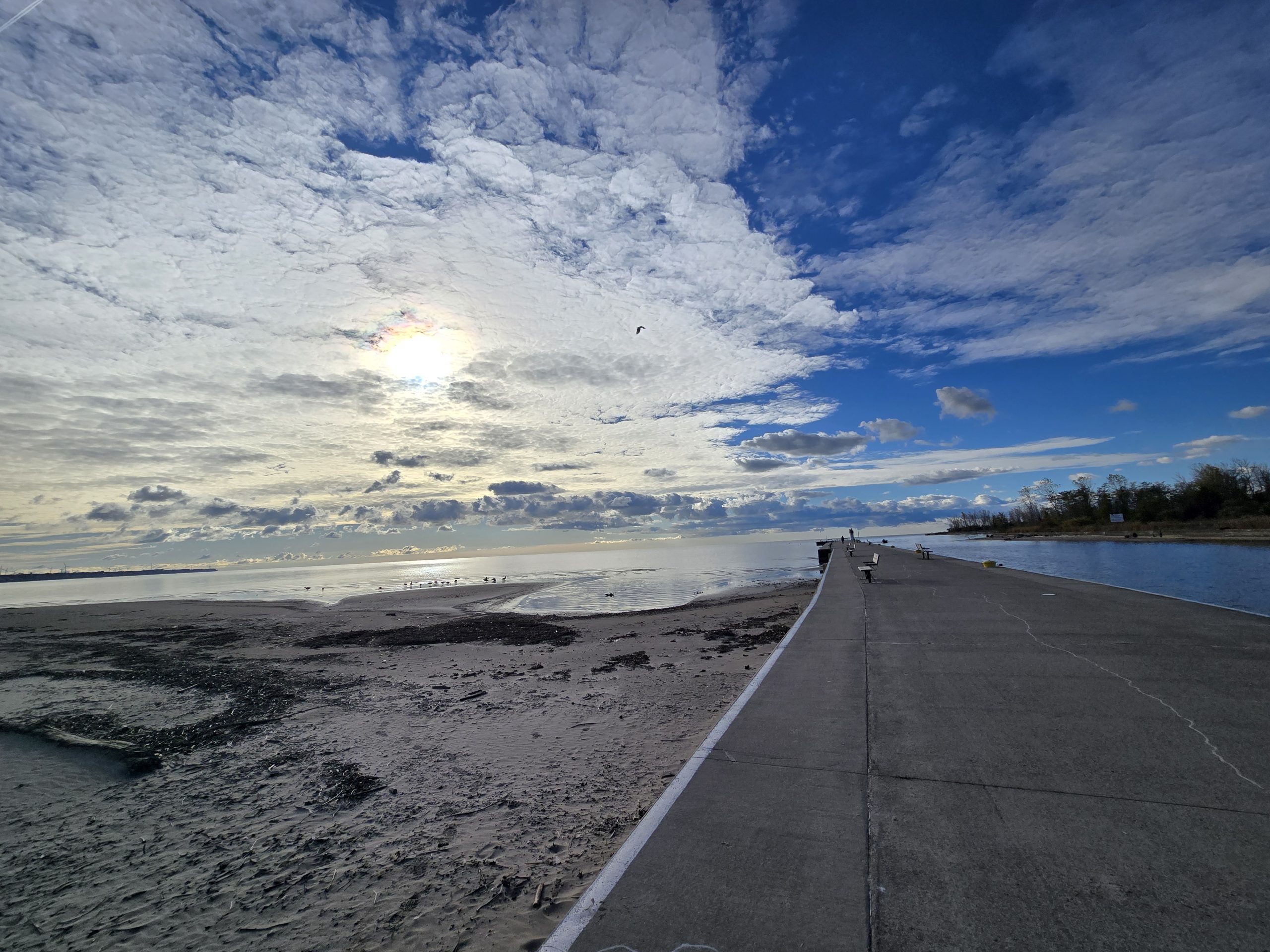 Port Burwell pier along the sandy beaches with blue cloudy skies.